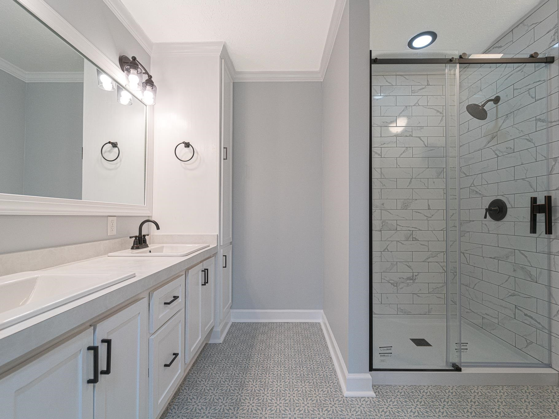 9961 Old Middlesex Road Middlesex, NC 27557 - Photo 17 of 30 a bathroom with a granite countertop sink a mirror and shower