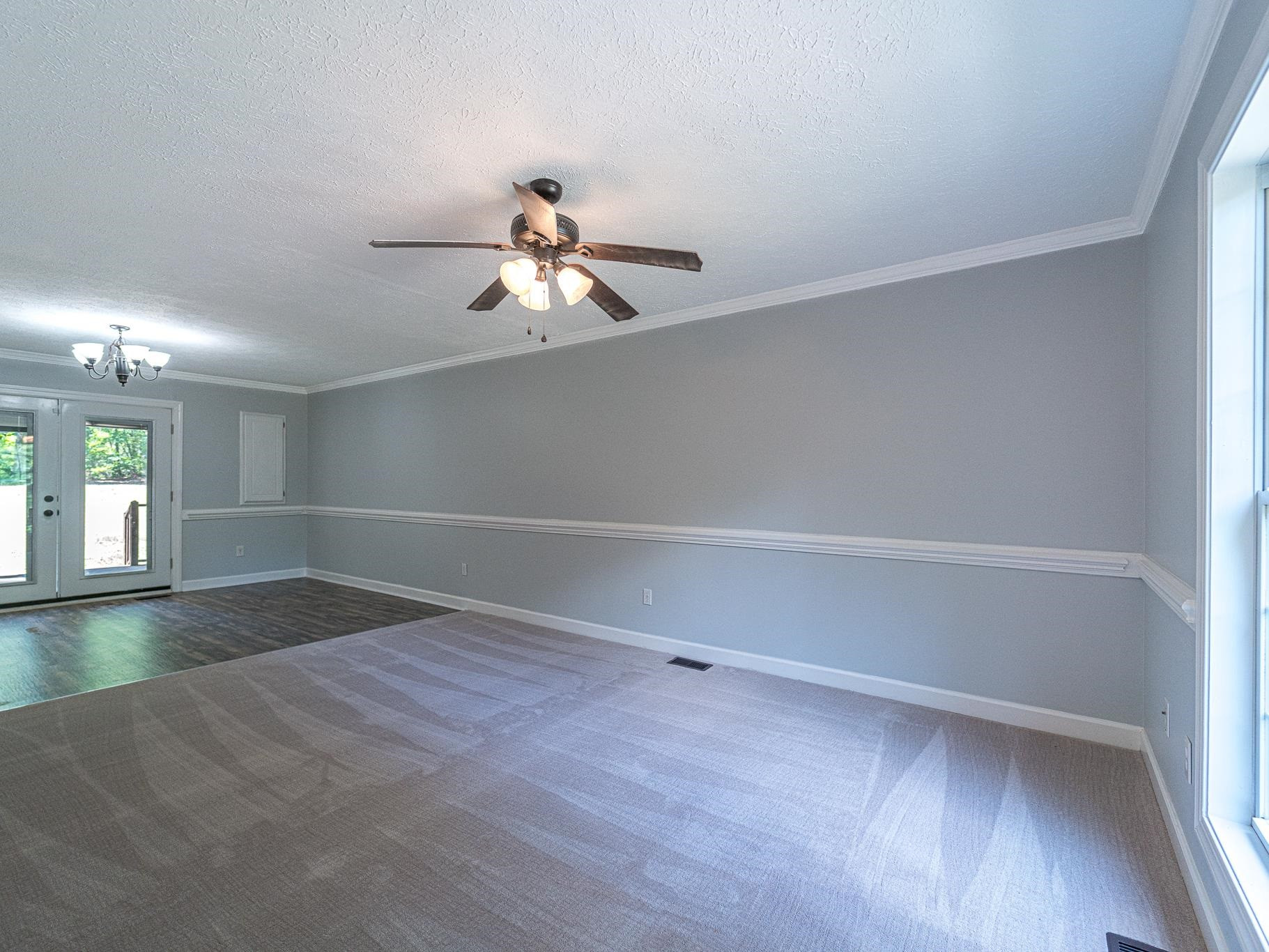 9961 Old Middlesex Road Middlesex, NC 27557 - Photo 4 of 30 a view of empty room with wooden floor and fan