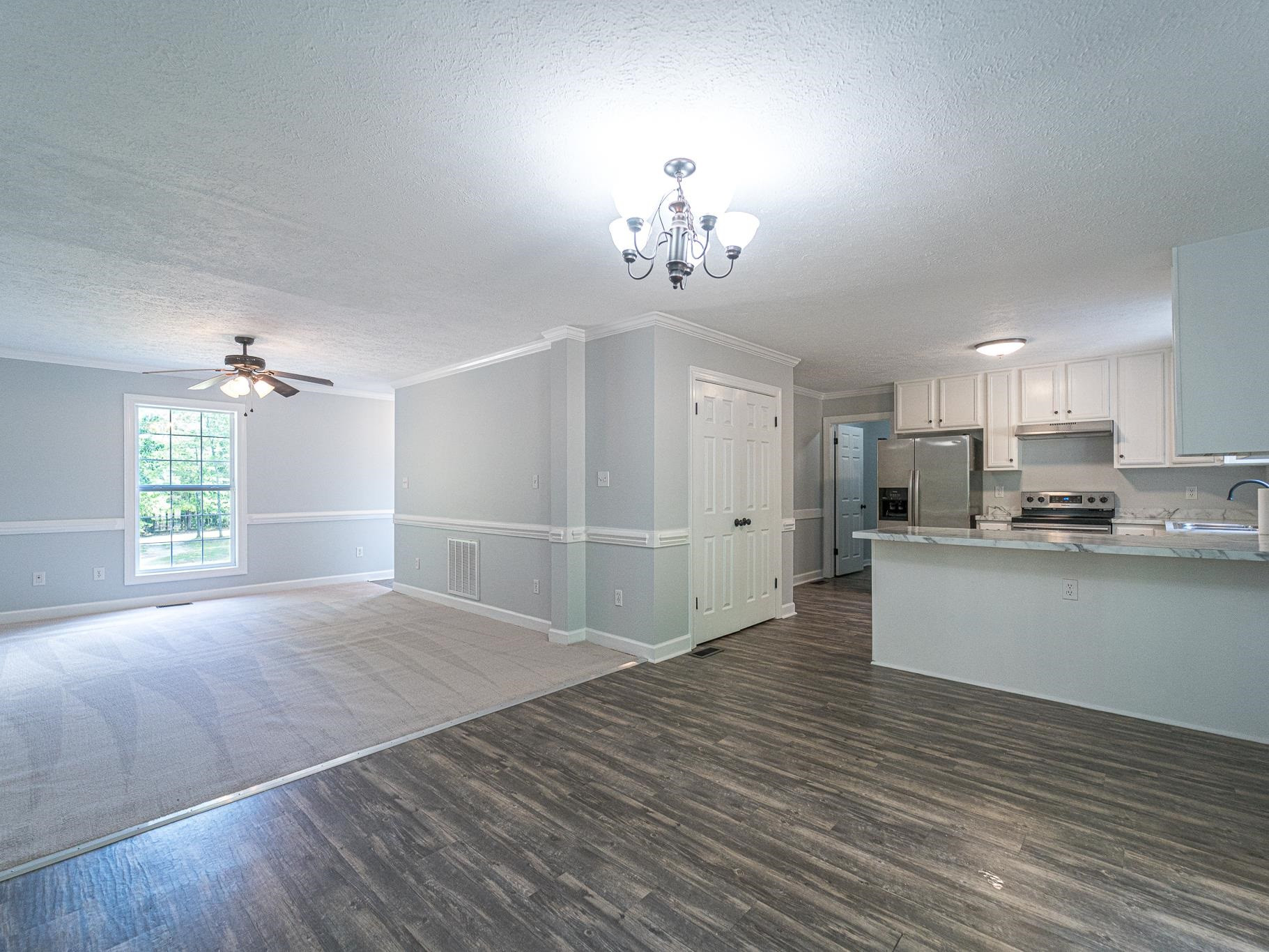 9961 Old Middlesex Road Middlesex, NC 27557 - Photo 7 of 30 a view of an empty room with kitchen and window