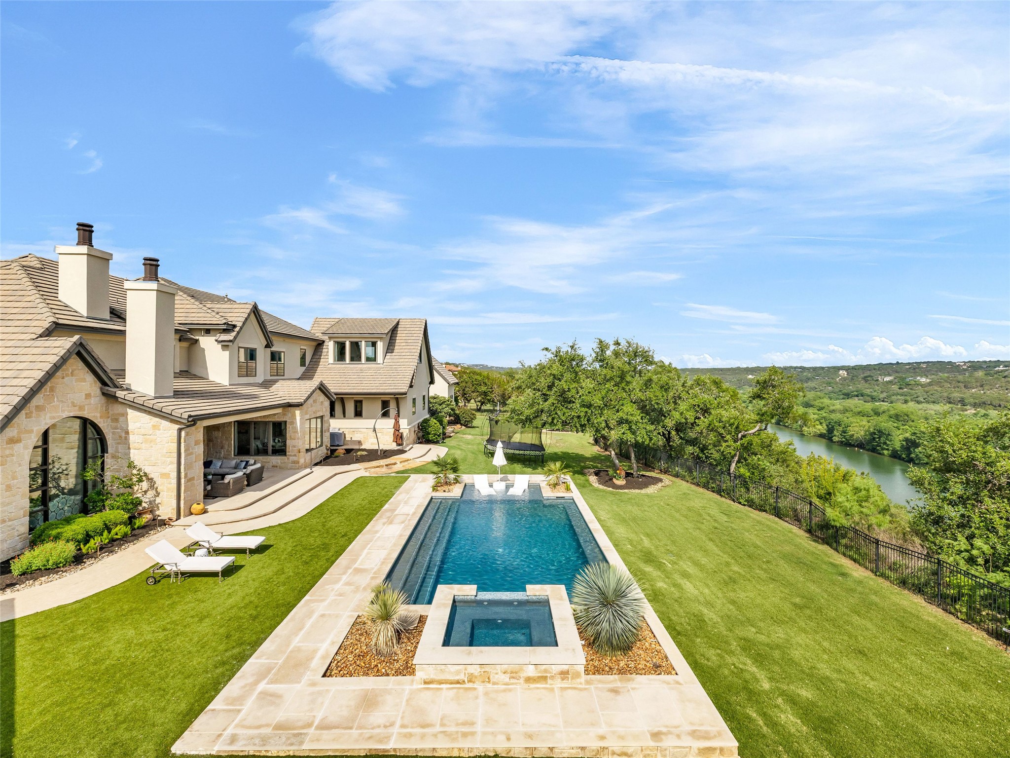 11705 Shoreview Overlook Austin, TX 78732 - Photo 5 of 34 a view of a swimming pool with lawn chairs and a yard