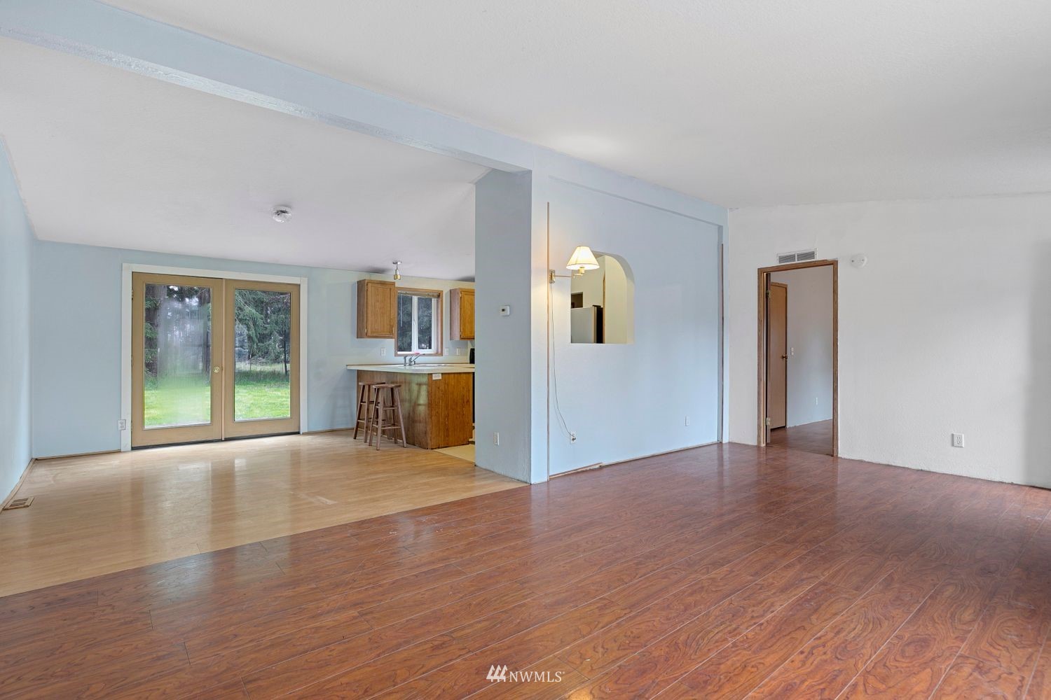 6323 190th Lane Southwest Rochester, WA 98579 - Photo 5 of 17 a view of an empty room with wooden floor and a window