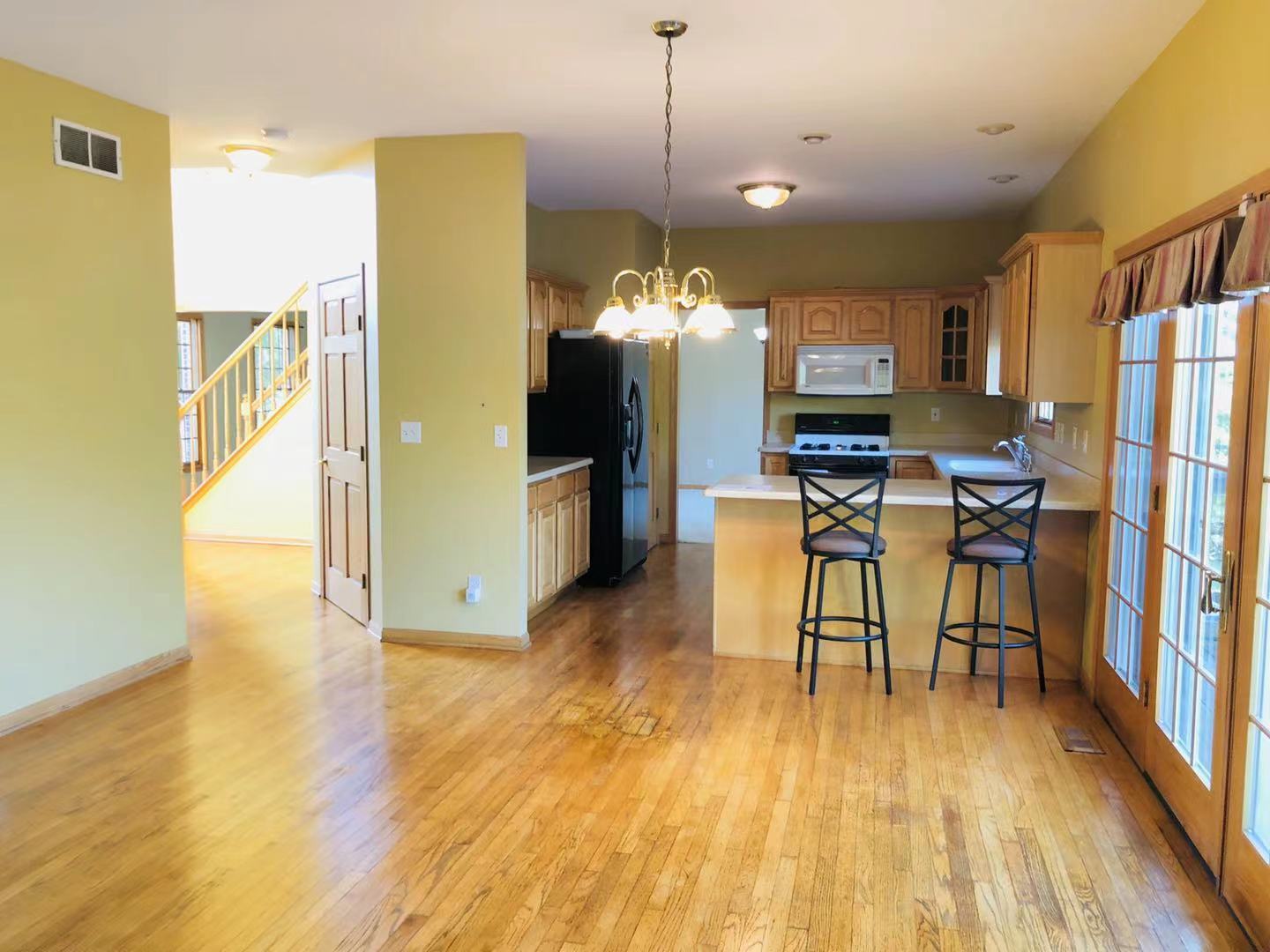 1381 Axcel Lane Sycamore, IL 60178 - Photo 11 of 39 a view of a dining room with furniture a chandelier and wooden floor