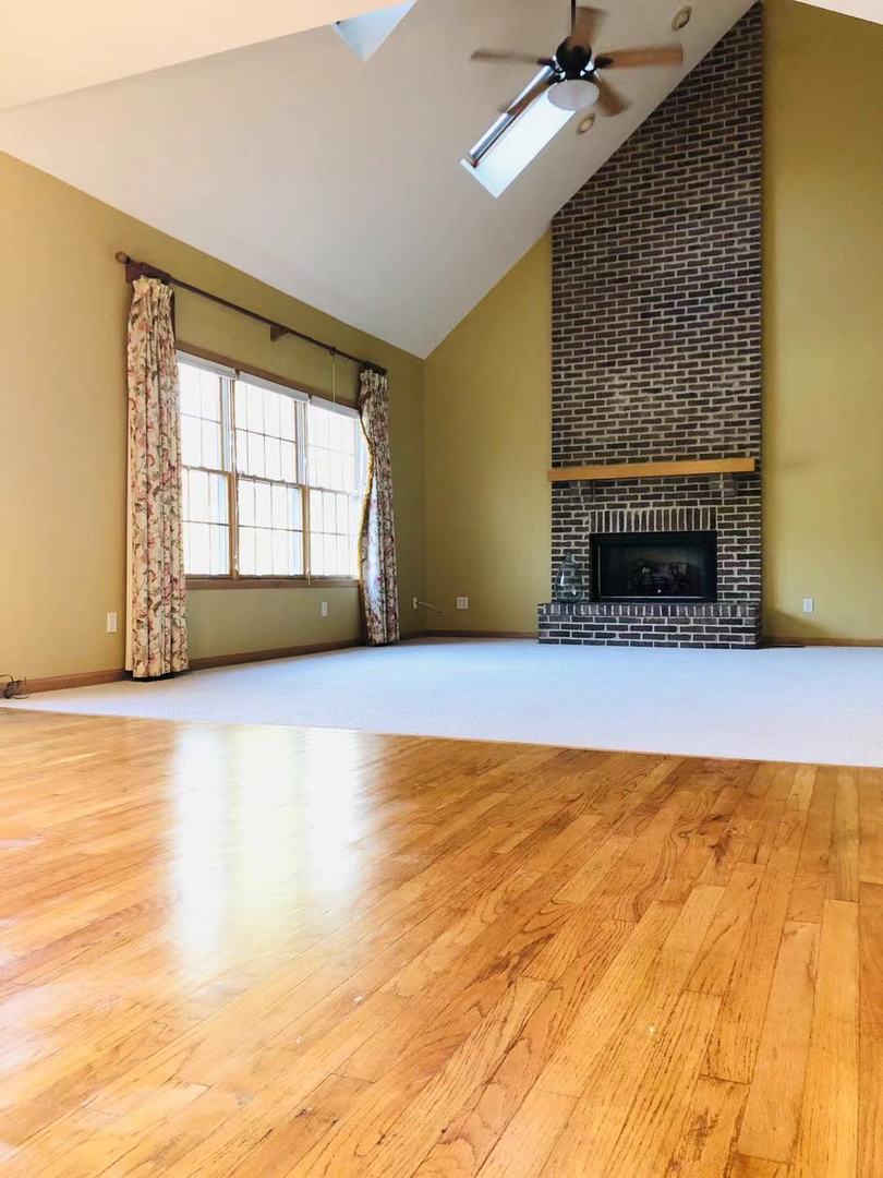 1381 Axcel Lane Sycamore, IL 60178 - Photo 13 of 39 a view of an empty room with a fireplace and a window