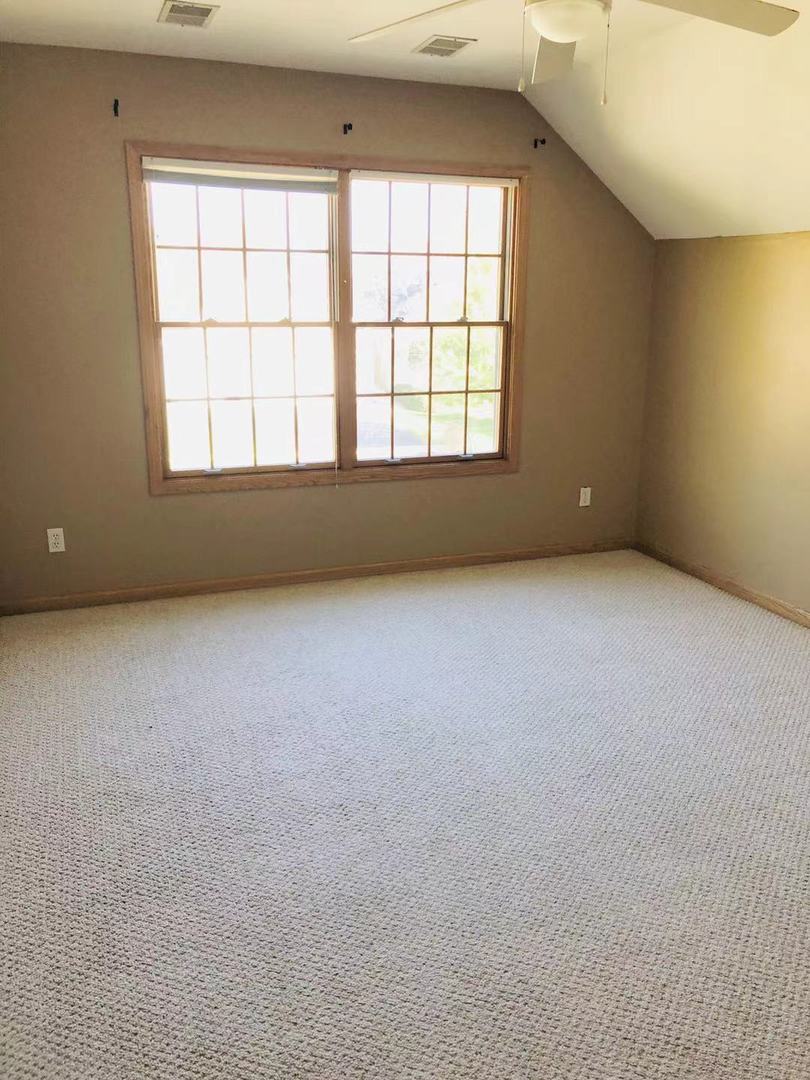 1381 Axcel Lane Sycamore, IL 60178 - Photo 19 of 39 an empty room with a fireplace and windows