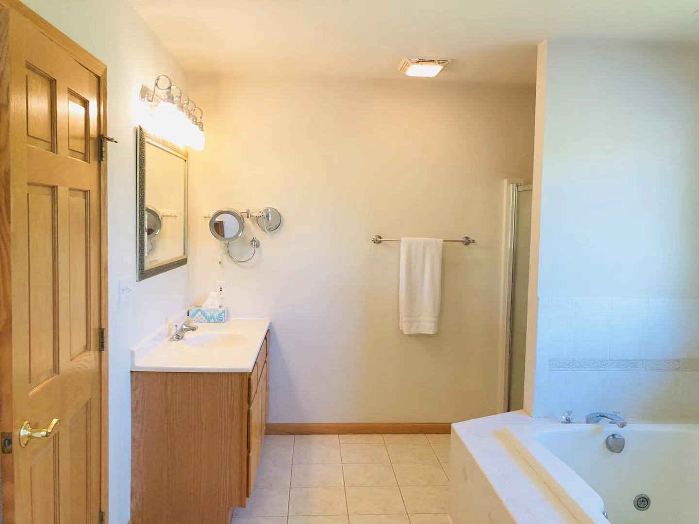 1381 Axcel Lane Sycamore, IL 60178 - Photo 20 of 39 a bathroom with a tub sink and mirror