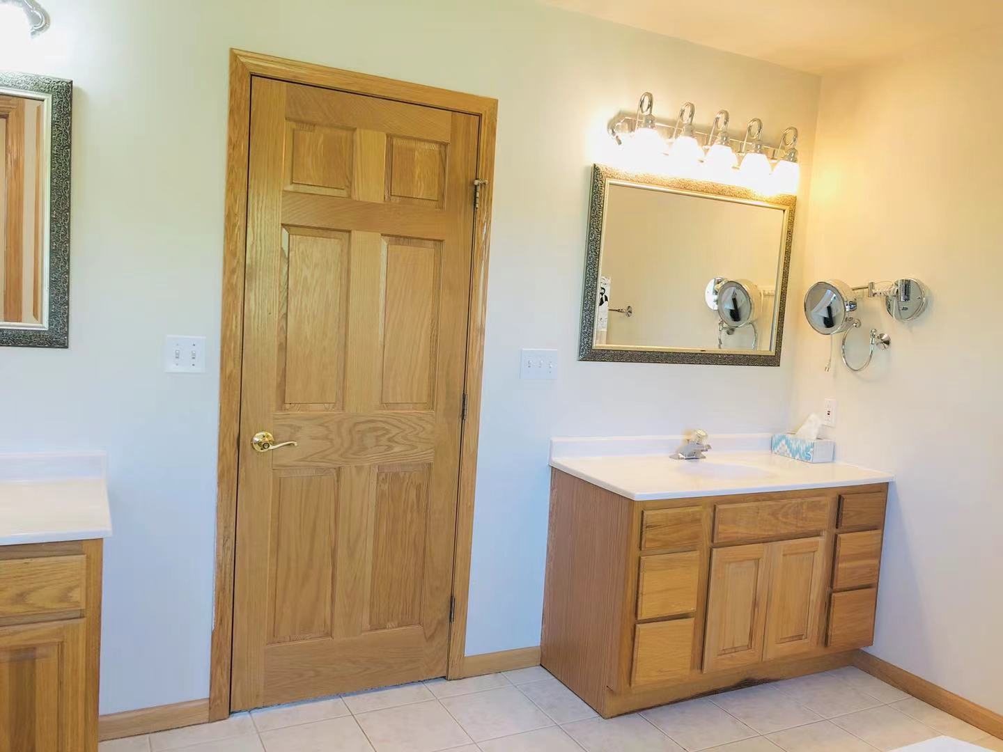 1381 Axcel Lane Sycamore, IL 60178 - Photo 21 of 39 a view of a bathroom with a sink and a mirror