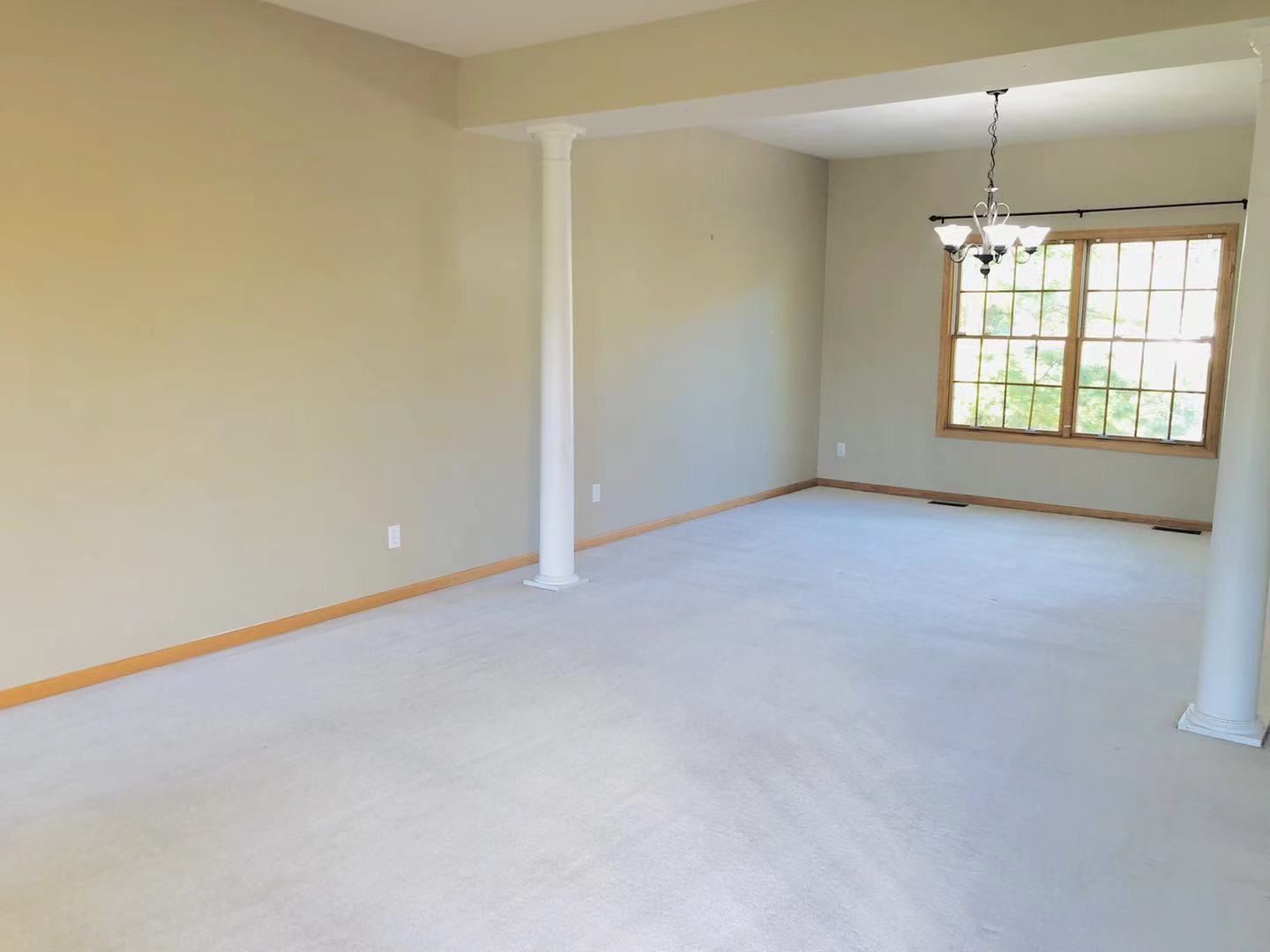1381 Axcel Lane Sycamore, IL 60178 - Photo 8 of 39 an empty room with windows and chandelier