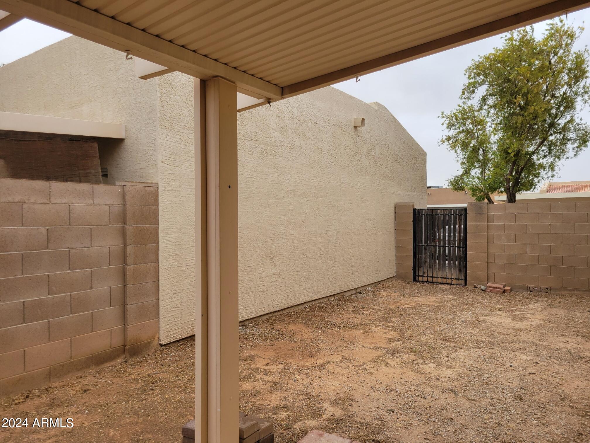 2300 East Magma Road, Unit 170 San Tan Valley, AZ 85143 - Photo 19 of 22 a view of an empty room with a brick wall and a window