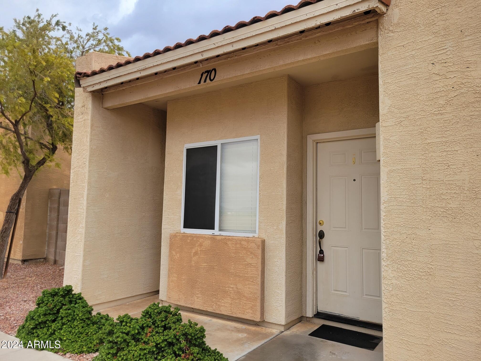 2300 East Magma Road, Unit 170 San Tan Valley, AZ 85143 - Photo 2 of 22 a front view of a house with a yard