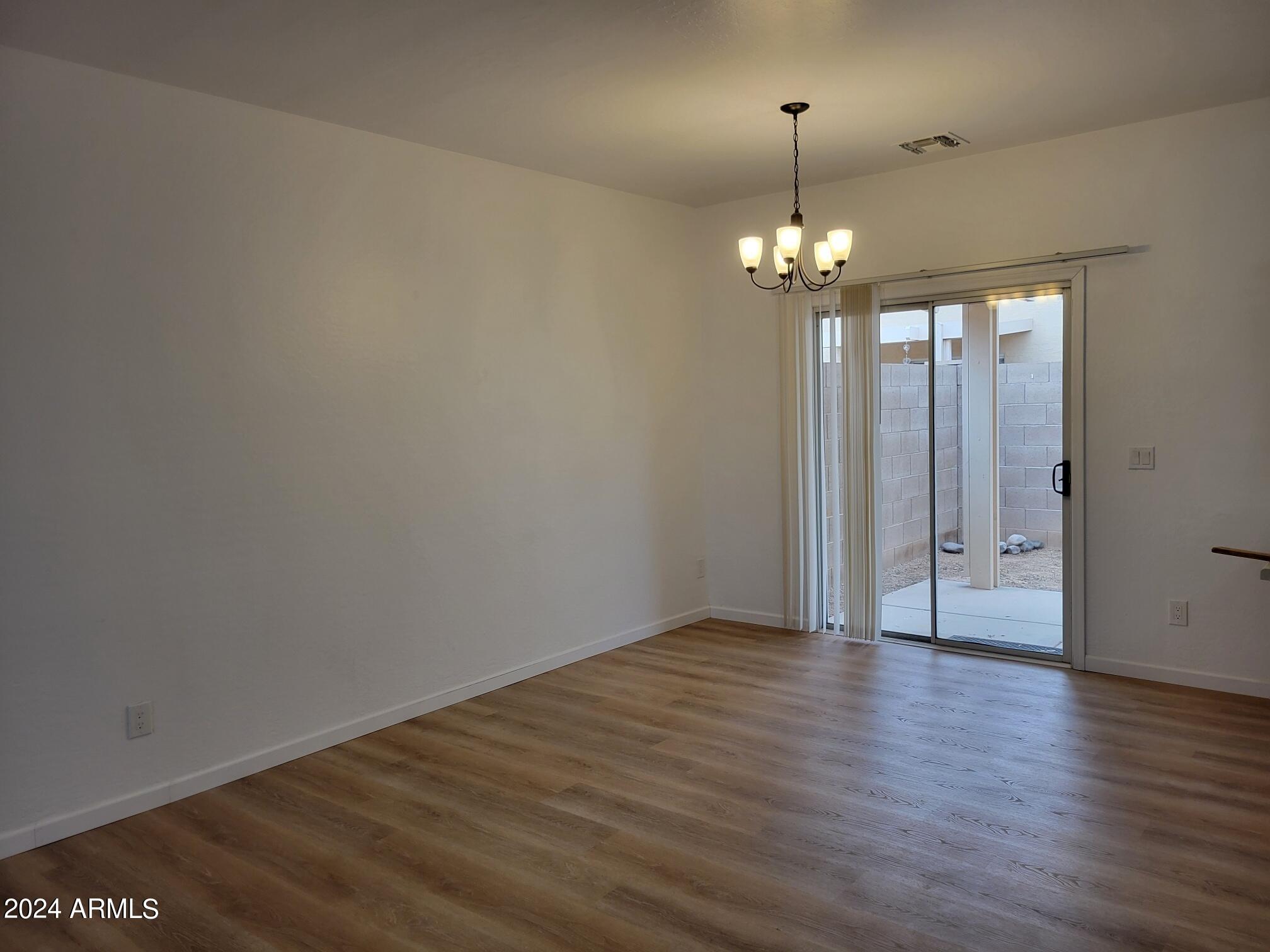 2300 East Magma Road, Unit 170 San Tan Valley, AZ 85143 - Photo 5 of 22 wooden floor in an empty room with a window