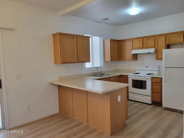 a kitchen with a stove a sink and a refrigerator