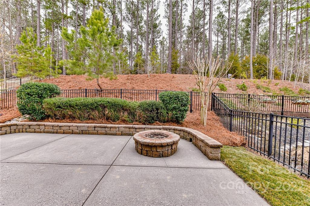 78078 Rillstone Drive Lancaster, SC 29720 - Photo 32 of 42 a view of a backyard with table and chairs and potted plants