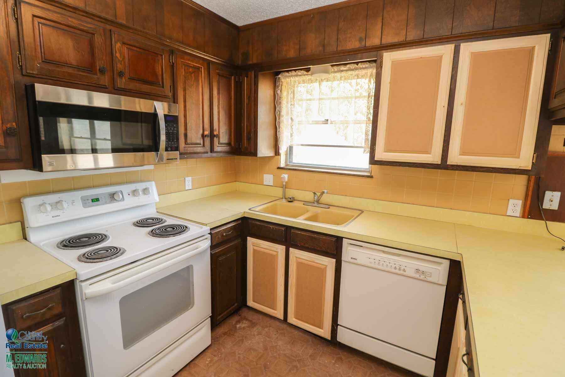 705 West Virginia Street Floydada, TX 79235 - Photo 6 of 15 a kitchen with a stove microwave and sink