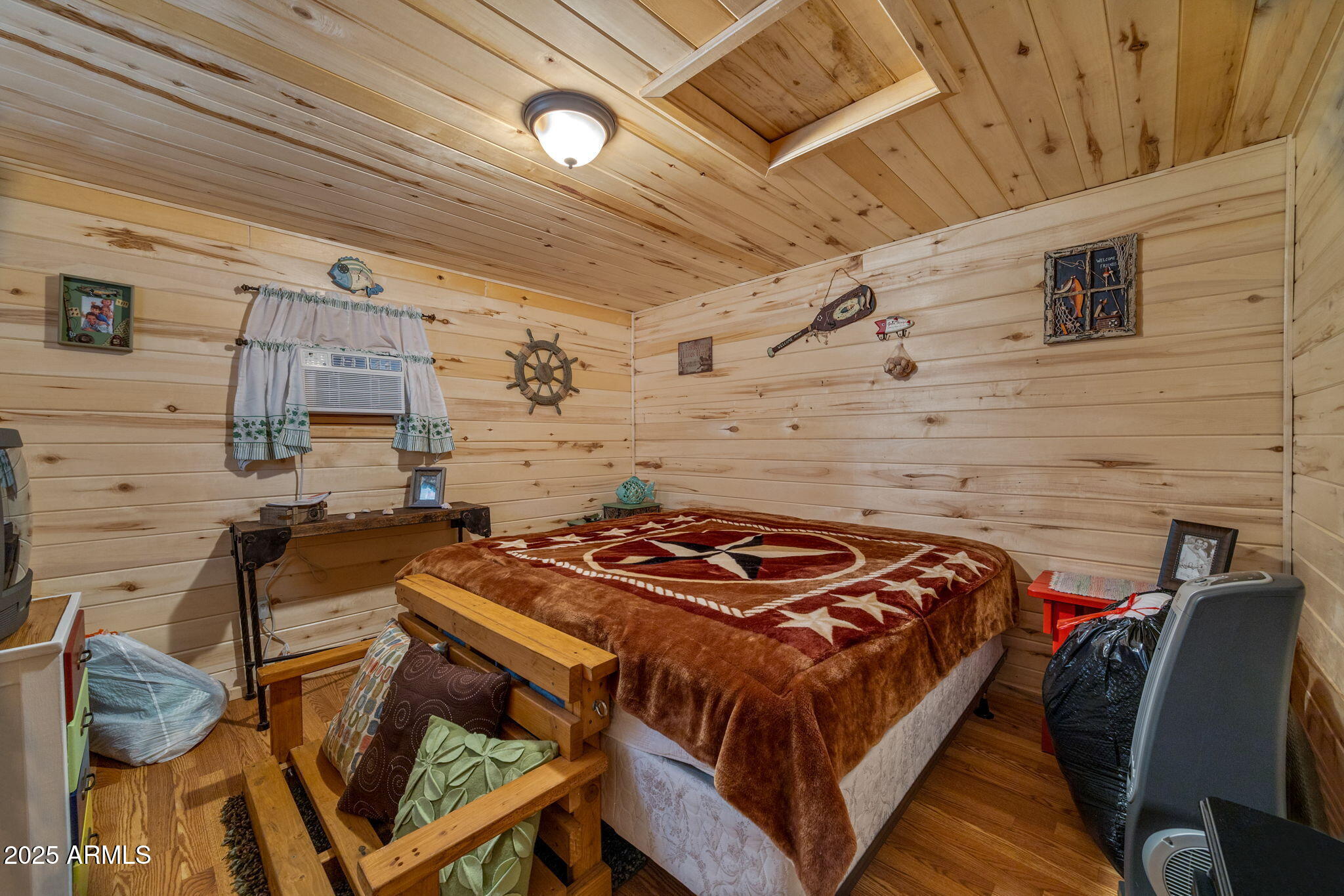 2979 Western Star Drive Overgaard, AZ 85933 - Photo 22 of 29 a bedroom with a bed and a table