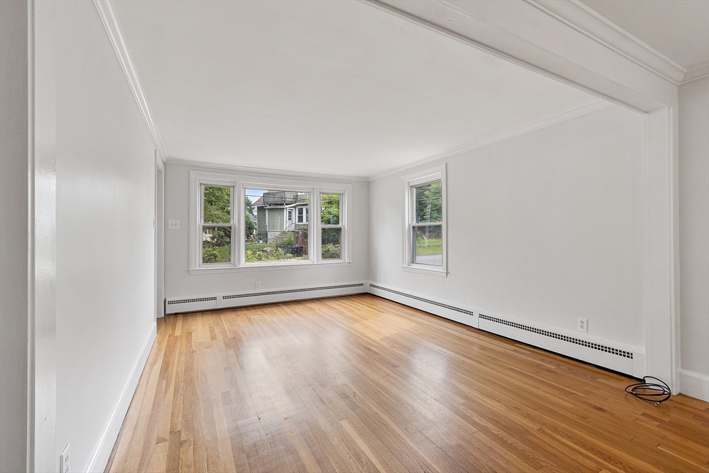 32 Pond Street Gardner, MA 01440 - Photo 12 of 34 an empty room with wooden floor and windows
