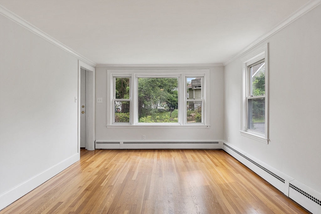 32 Pond Street Gardner, MA 01440 - Photo 13 of 34 an empty room with wooden floor and a window