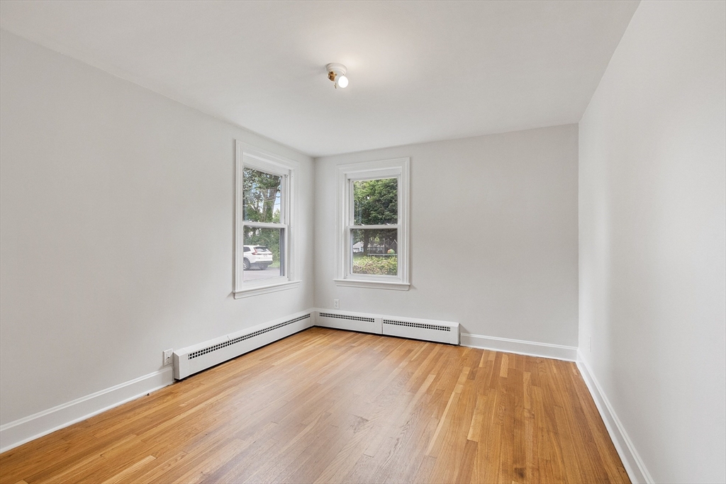 32 Pond Street Gardner, MA 01440 - Photo 20 of 34 an empty room with wooden floor and windows