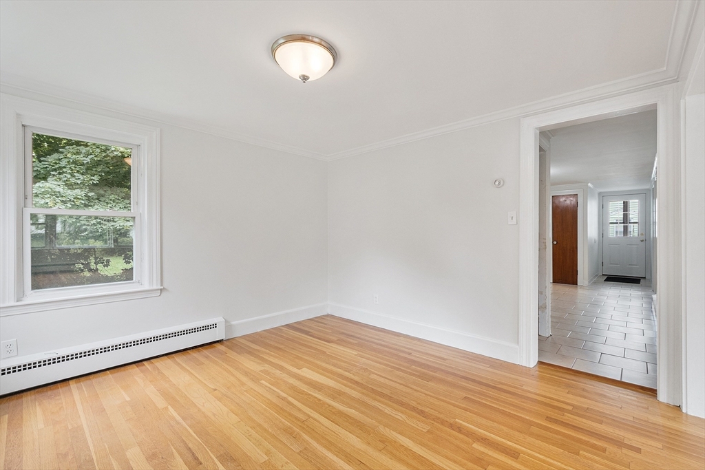 32 Pond Street Gardner, MA 01440 - Photo 22 of 34 an empty room with wooden floor and windows