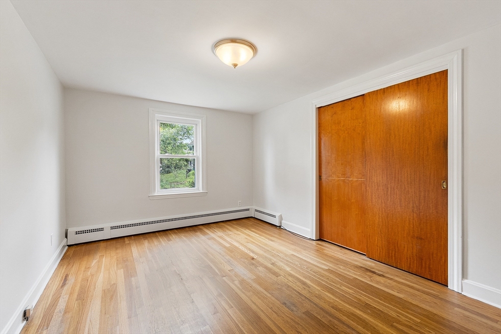 32 Pond Street Gardner, MA 01440 - Photo 24 of 34 an empty room with wooden floor and windows