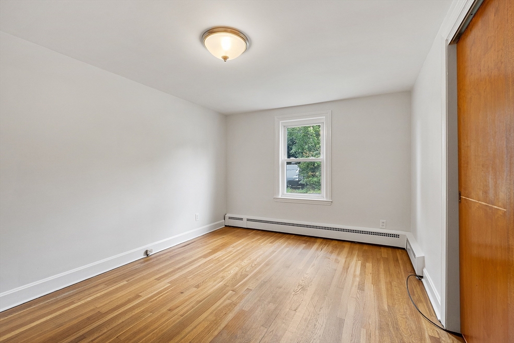32 Pond Street Gardner, MA 01440 - Photo 25 of 34 an empty room with wooden floor and windows