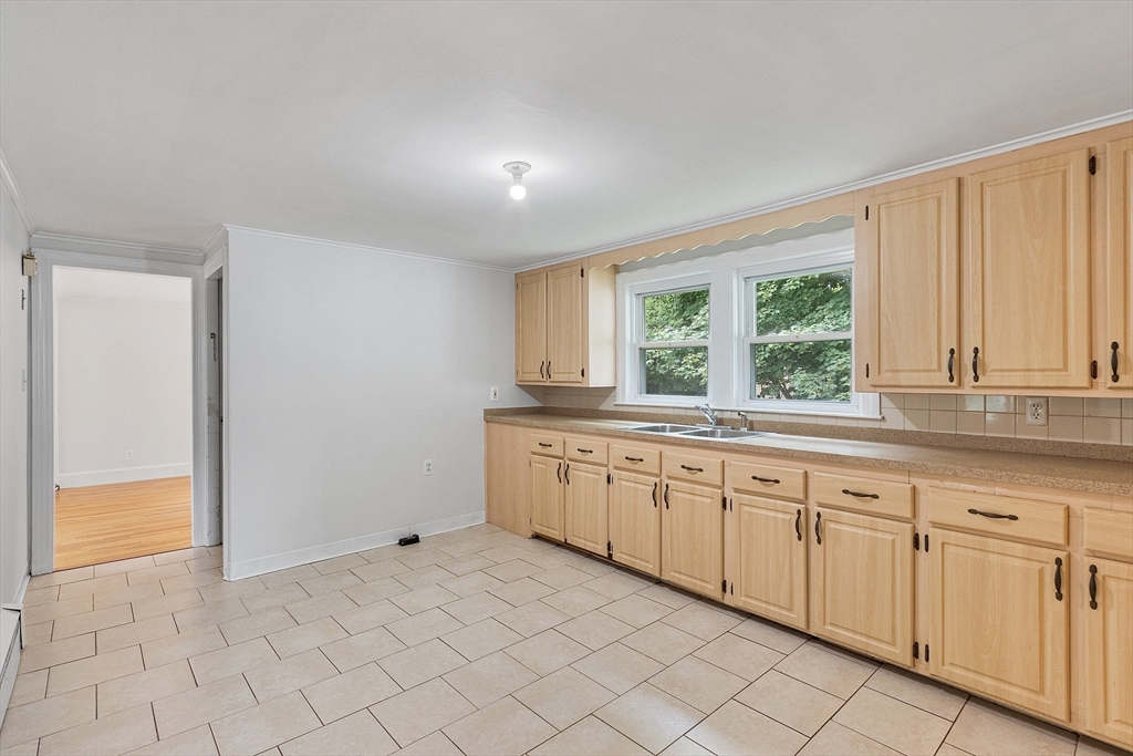 32 Pond Street Gardner, MA 01440 - Photo 6 of 34 a large white kitchen with white cabinets and a window