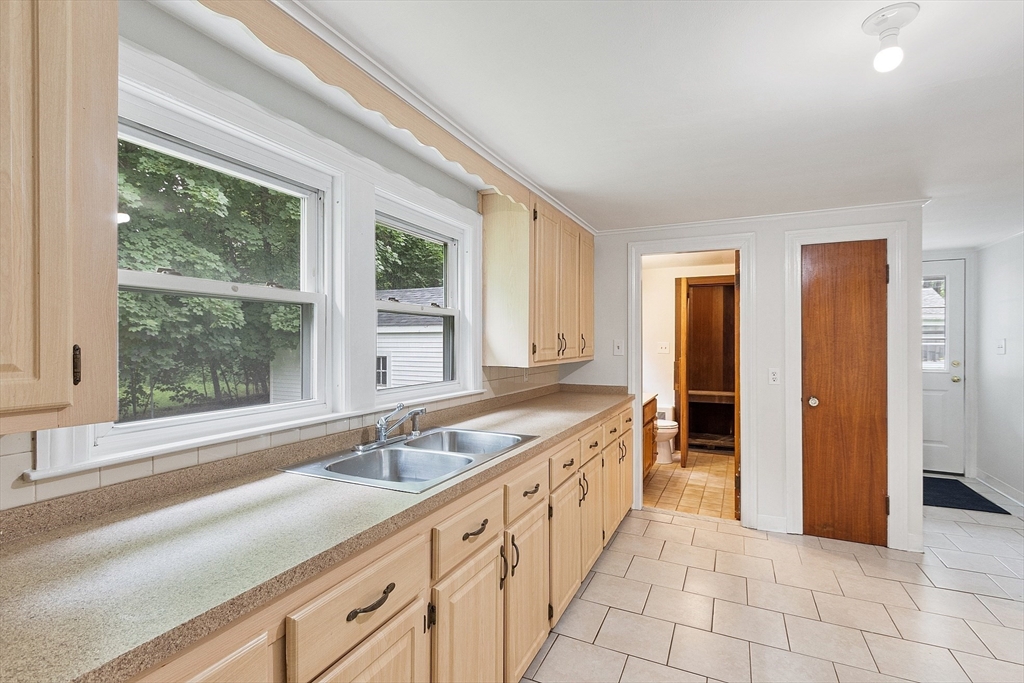 32 Pond Street Gardner, MA 01440 - Photo 8 of 34 a bathroom with a granite countertop sink and a large mirror