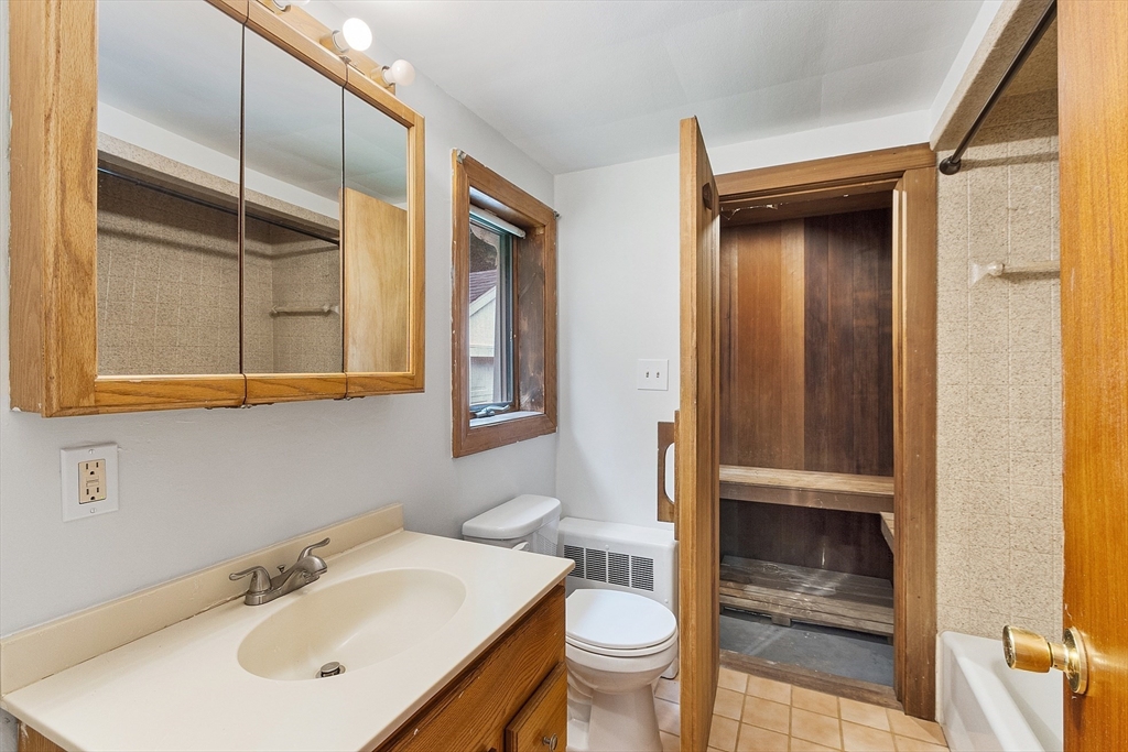 32 Pond Street Gardner, MA 01440 - Photo 9 of 34 a bathroom with a sink and mirror with toilet
