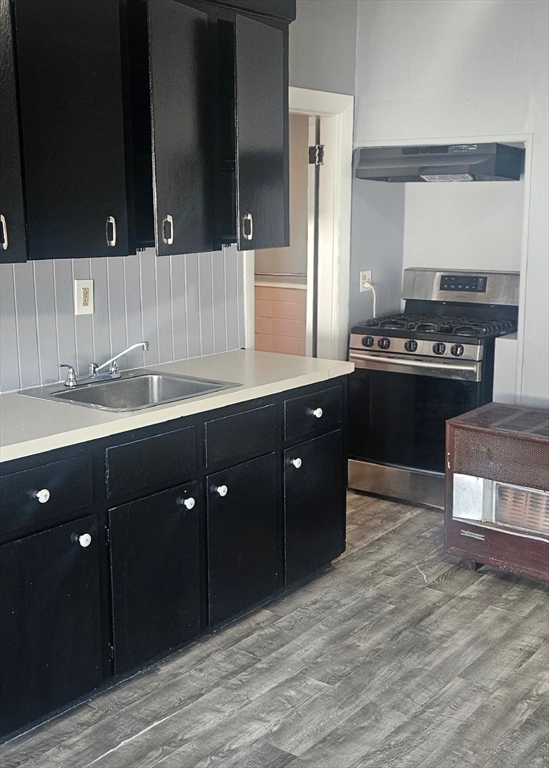 111 Covel Street, Unit 3 Fall River, MA 02723 - Photo 5 of 11 a kitchen with stainless steel appliances granite countertop a stove a sink and a refrigerator