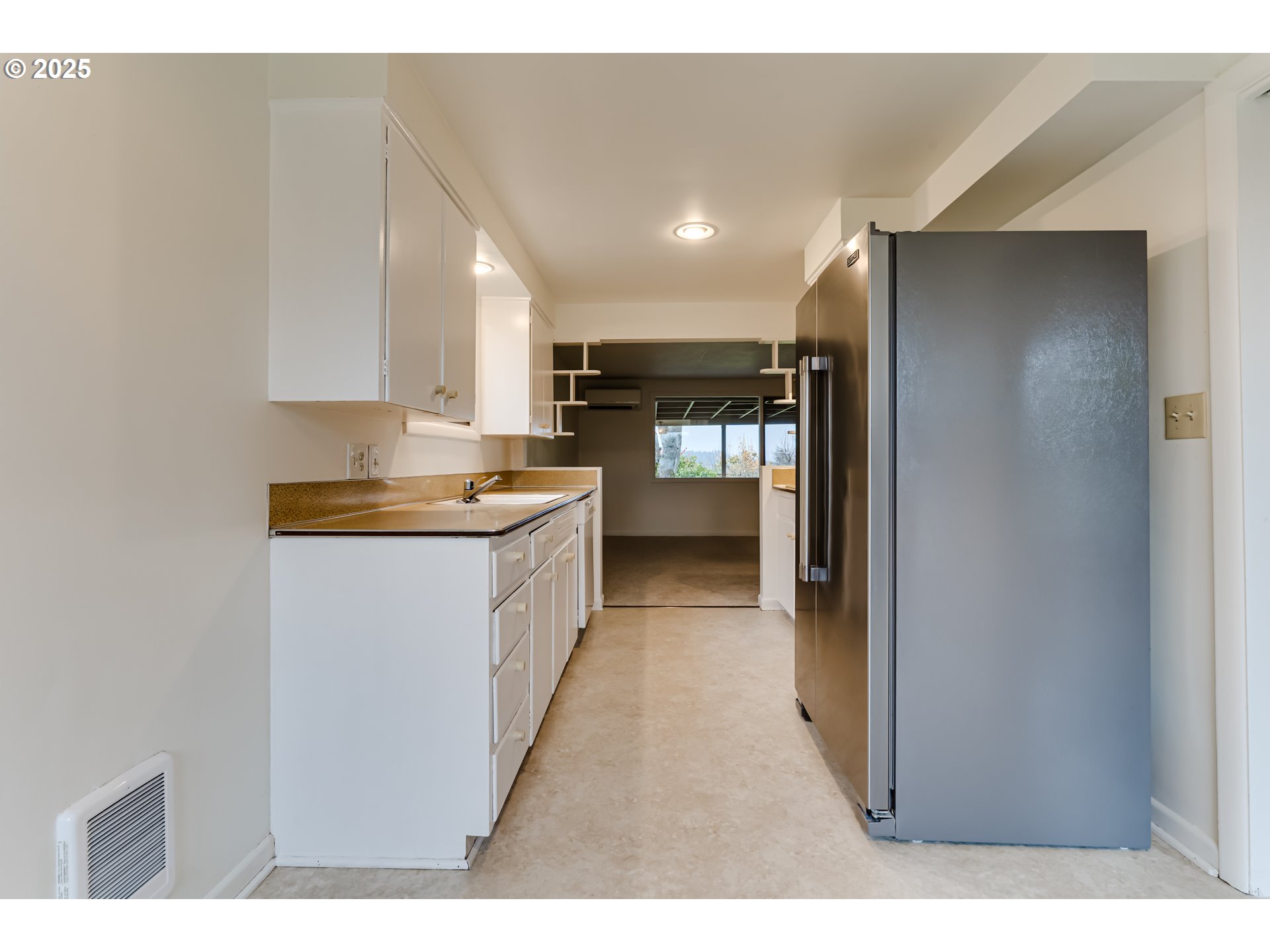 2550 Lawrence Street Eugene, OR 97405 - Photo 15 of 48 a open kitchen with white cabinets and stainless steel appliances