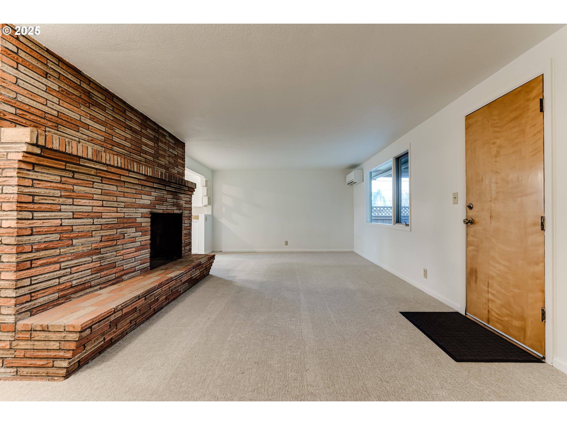 2550 Lawrence Street Eugene, OR 97405 - Photo 19 of 48 a view of an empty room with a fireplace and a window