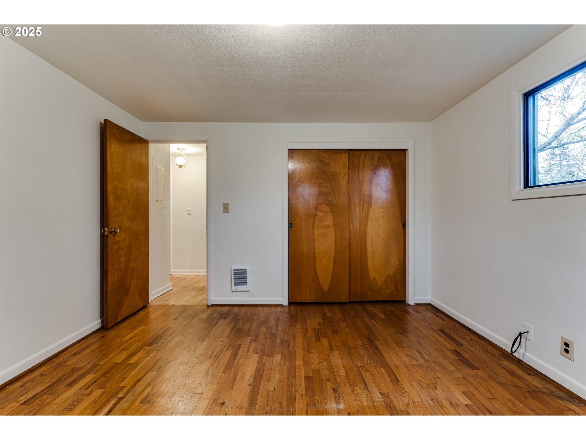 2550 Lawrence Street Eugene, OR 97405 - Photo 26 of 48 a view of an empty room with wooden floor and closet