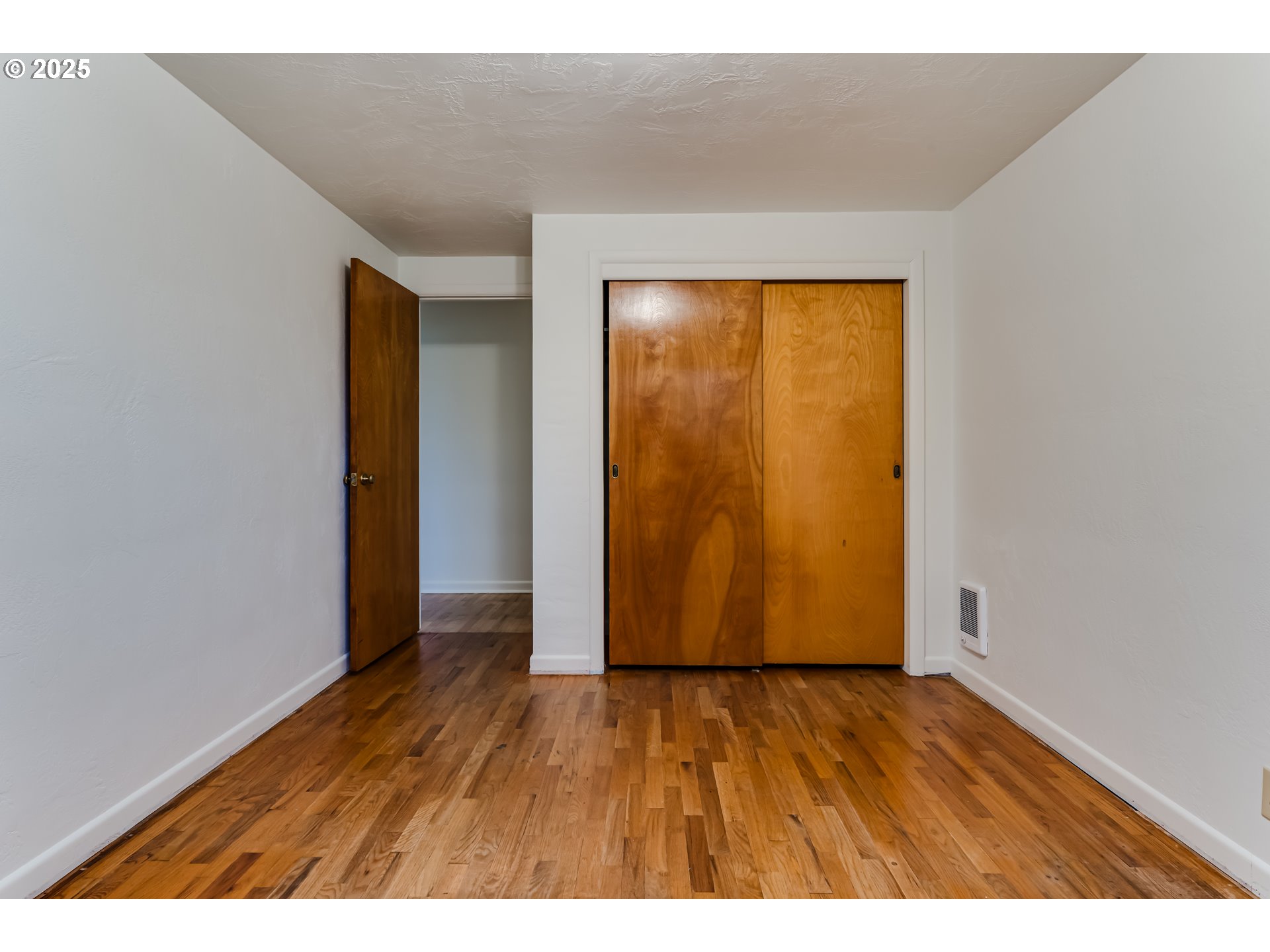 2550 Lawrence Street Eugene, OR 97405 - Photo 28 of 48 a view of an empty room with wooden floor and a window
