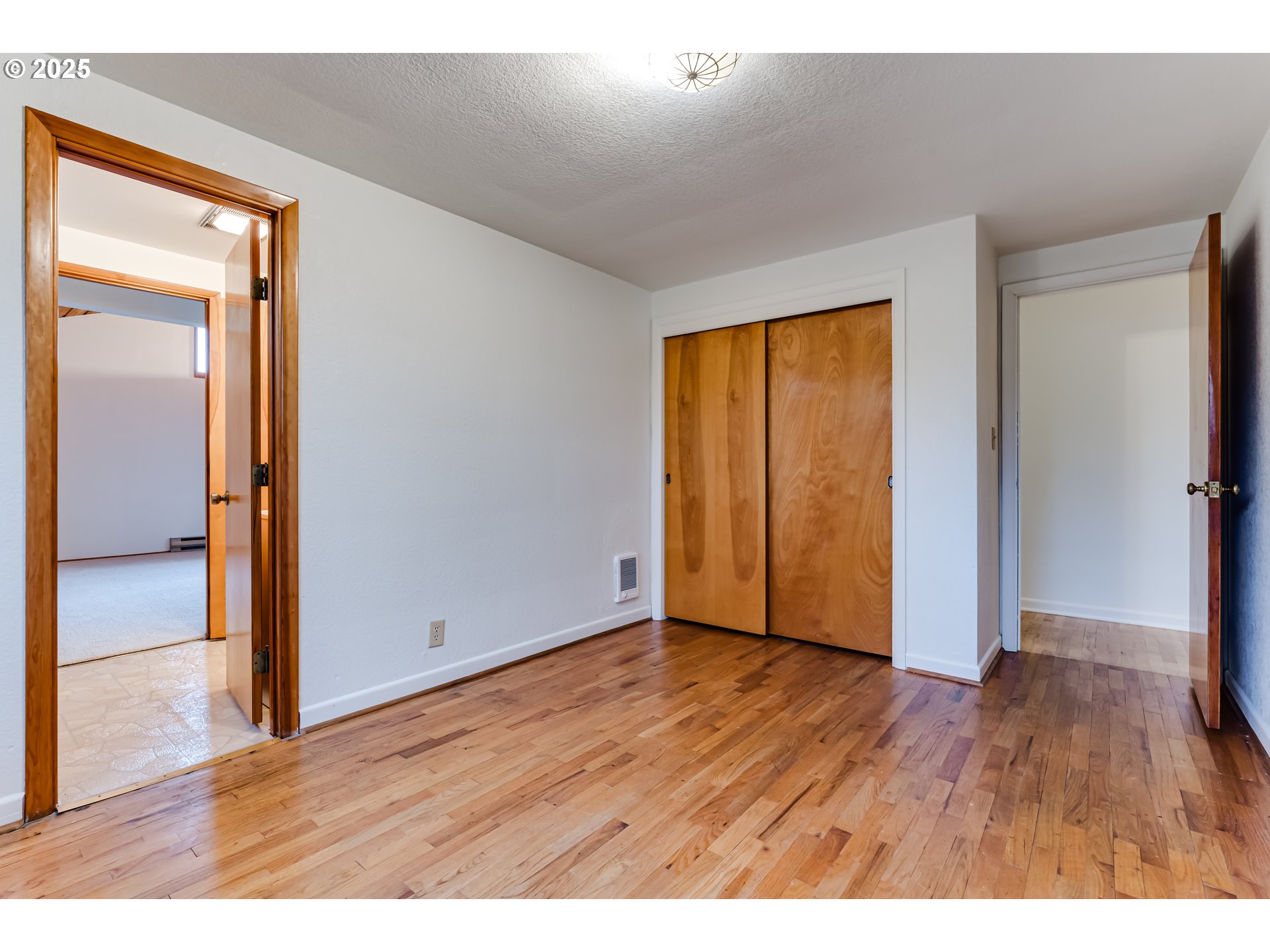 2550 Lawrence Street Eugene, OR 97405 - Photo 31 of 48 a view of an empty room with wooden floor and a window
