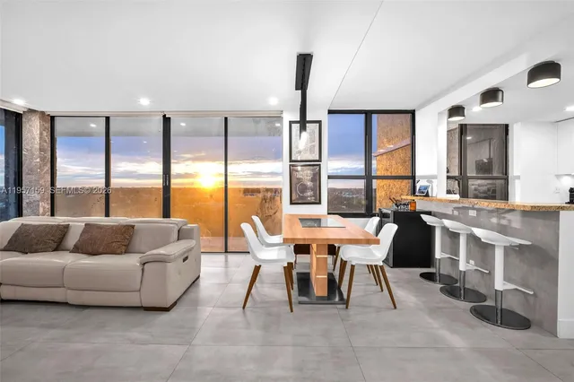 a living room with furniture and large windows