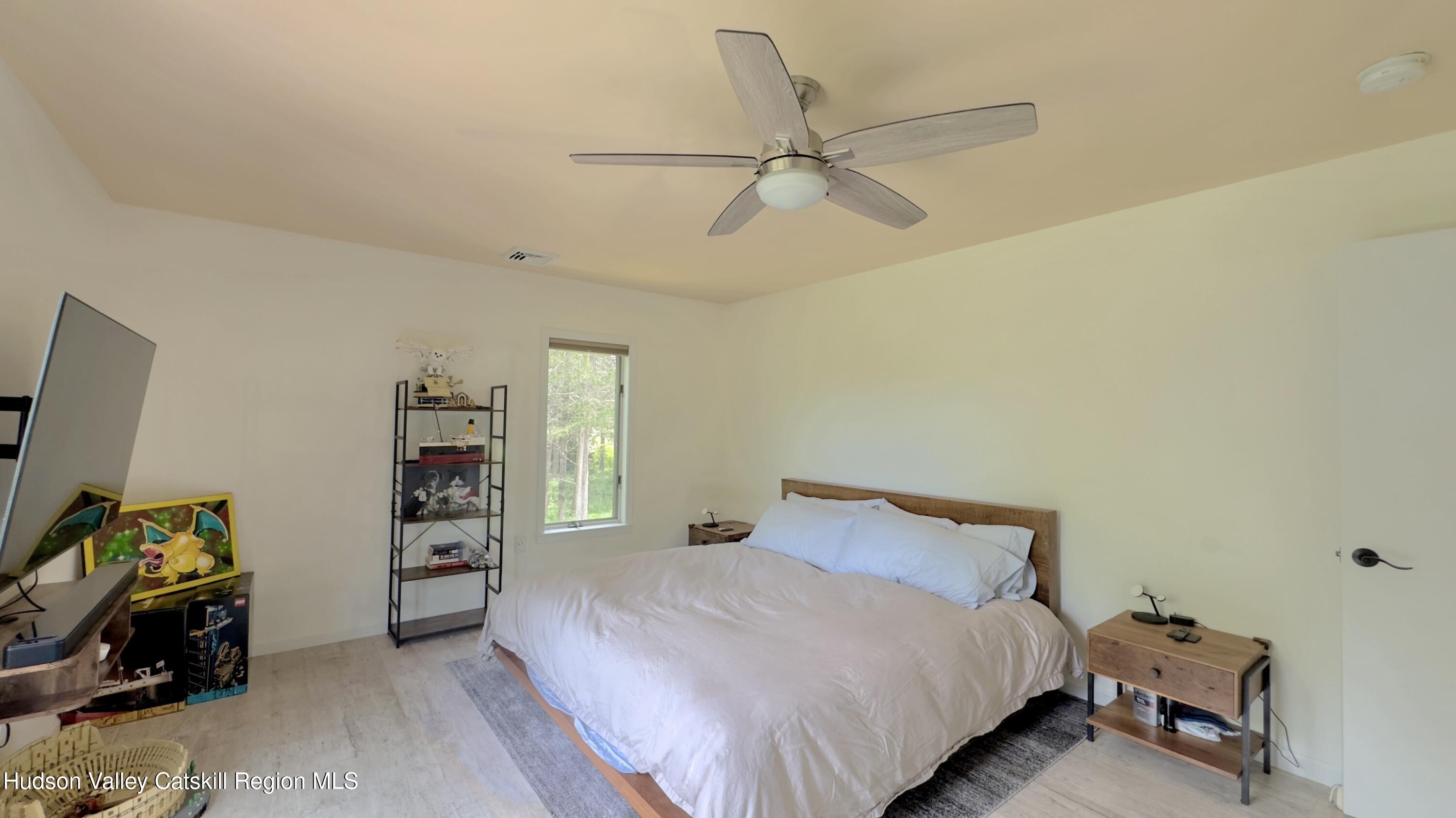 3223 Sleepy Hollow Road Athens, NY 12015 - Photo 22 of 55 a bedroom with a bed and a tv