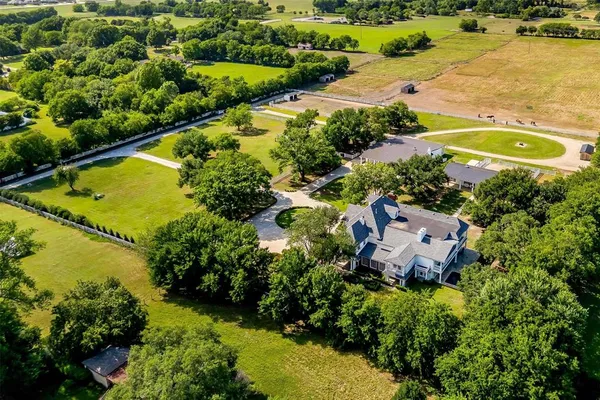 an aerial view of residential houses with outdoor space and swimming pool