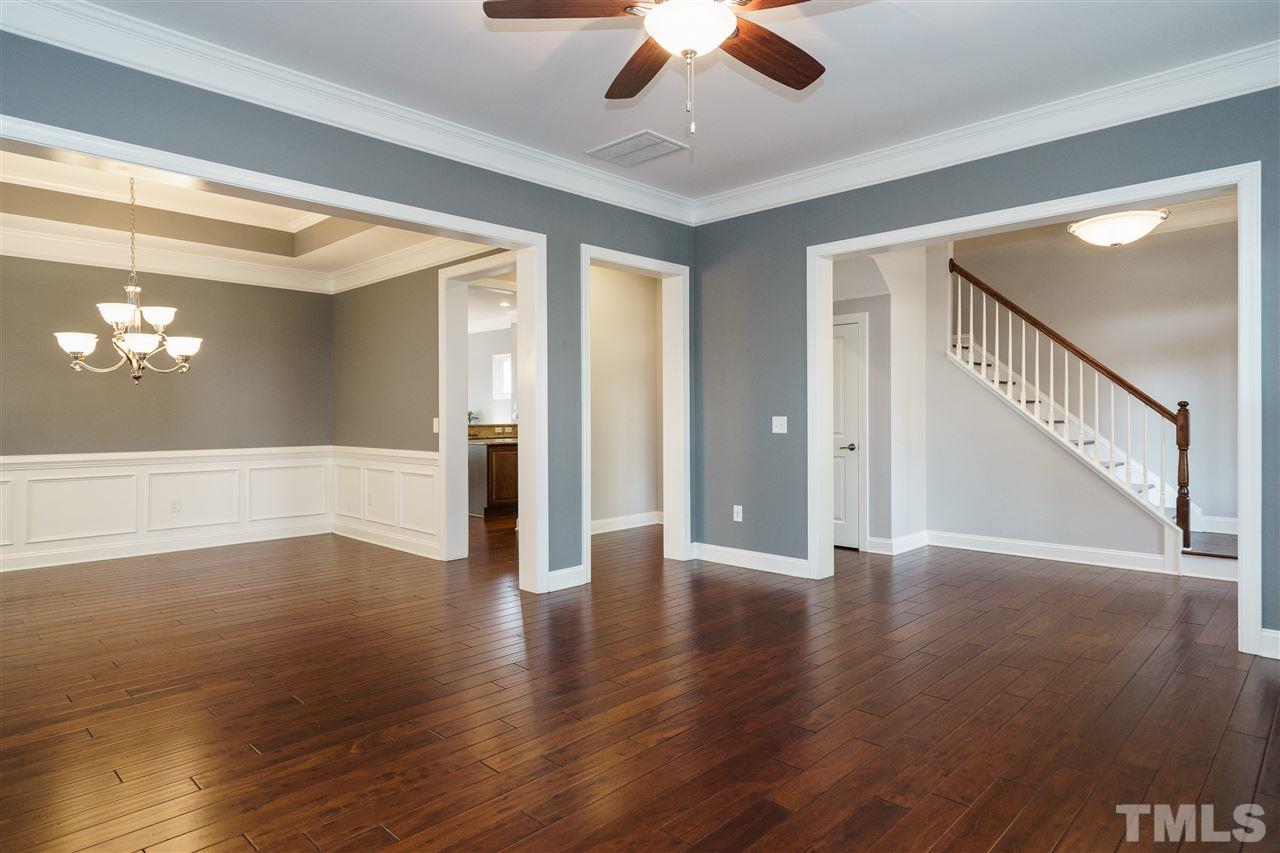 1334 Rodessa Run Raleigh, NC 27607 - Photo 6 of 25 a view of an empty room with wooden floor and a window