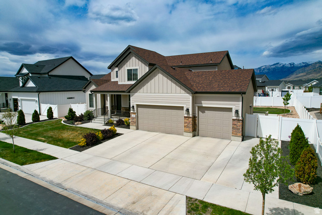 1434 West Stable Street Lindon, UT 84042 - Photo 57 of 76 View of front of home with board and batten siding, an attached garage, covered porch, a residential view, and driveway
