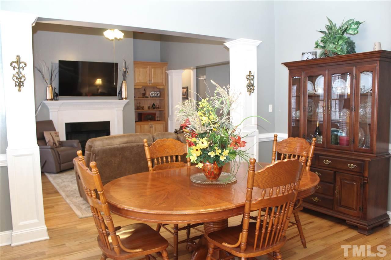 288 North Old Lantern Road Timberlake, NC 27583 - Photo 11 of 20 a dining room with furniture a fireplace and wooden floor