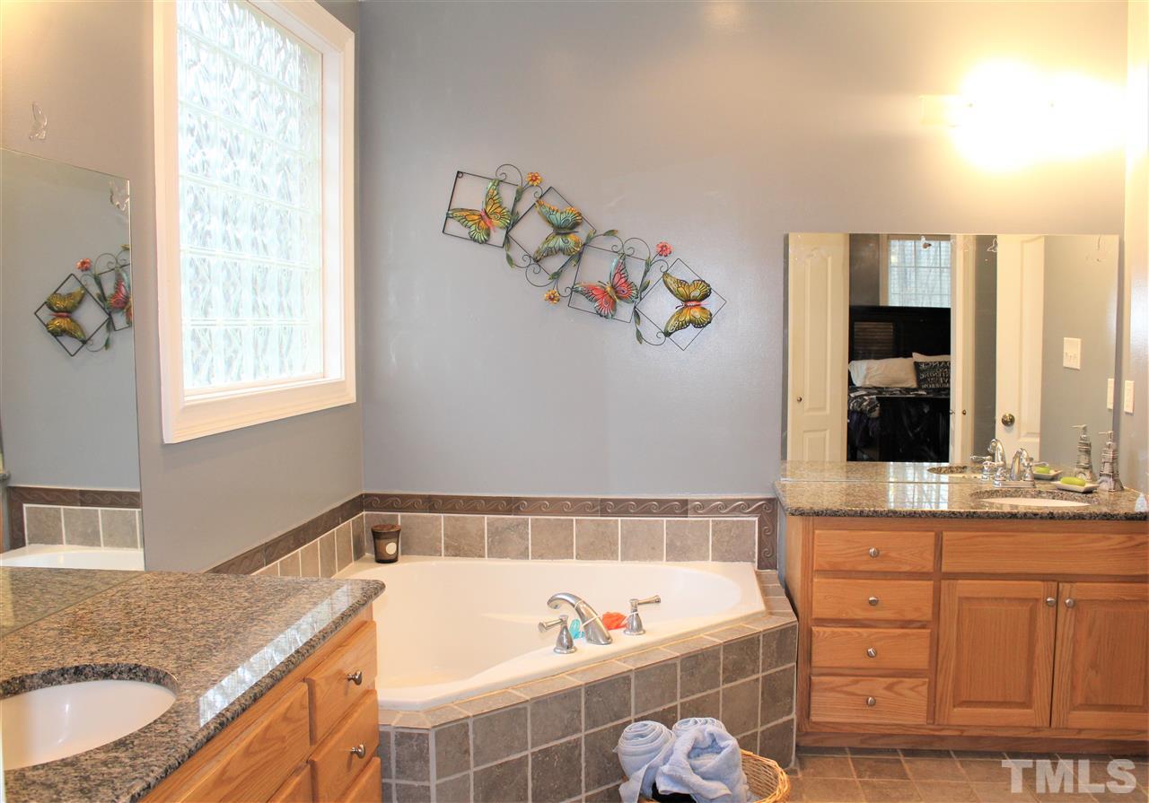288 North Old Lantern Road Timberlake, NC 27583 - Photo 15 of 20 a bathroom with a tub sink and mirror