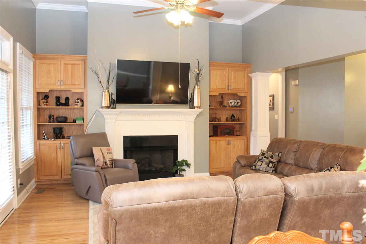 288 North Old Lantern Road Timberlake, NC 27583 - Photo 5 of 20 a living room with furniture a flat screen tv and a fireplace