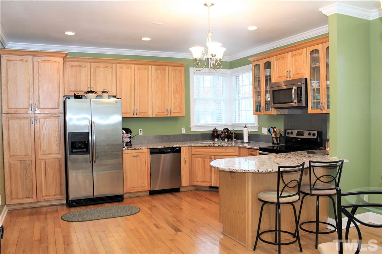 288 North Old Lantern Road Timberlake, NC 27583 - Photo 6 of 20 a kitchen with stainless steel appliances granite countertop a stove a sink a refrigerator and island