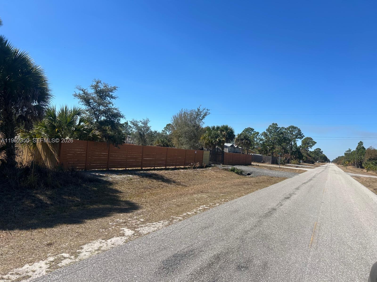648 Hunting Club Avenue Clewiston, FL 33440 - Photo 12 of 22 a view of a road with a yard
