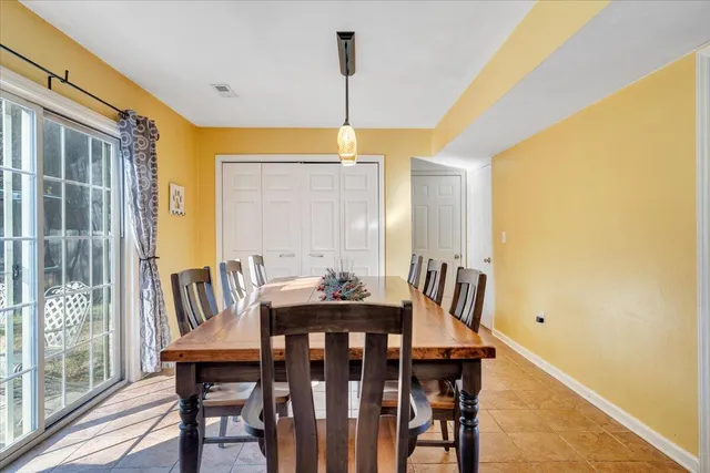 a view of a dining room with furniture and window