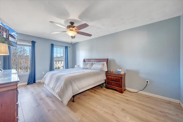 a bedroom with a bed and wooden floor