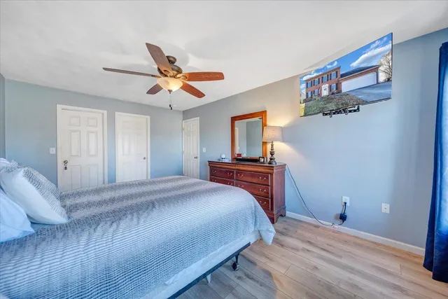 a bedroom with a bed and a chandelier