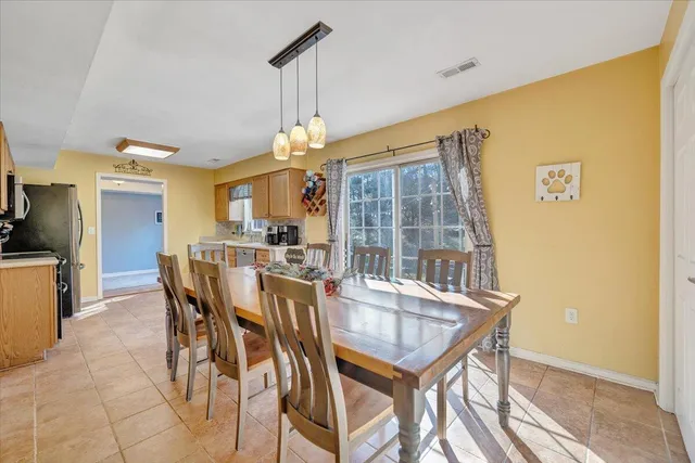 a dining room with furniture and window