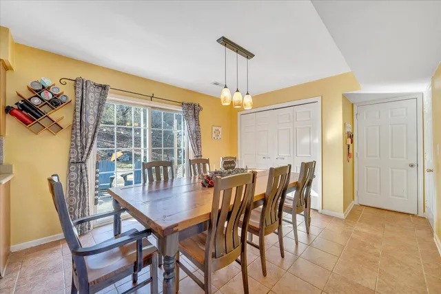 a dining room with furniture and window