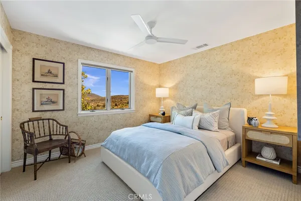 a bedroom with a bed a couch and a window