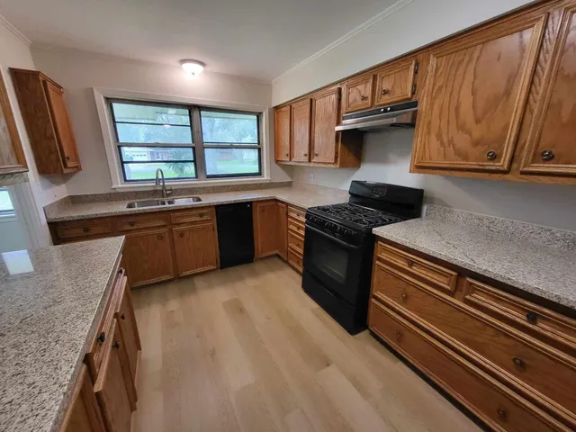 a kitchen with stainless steel appliances granite countertop sink and cabinets